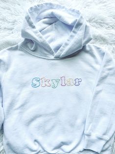 Personalized hand embroidered hooded sweatshirt.  Created on a white hooded sweatshirt with simple stitching in an array of pastels.  A name, location or a simple word all work great for this custom design.  This listing is for one single name or word only.  Please contact me if you're looking to add additional text before ordering.  Each sweatshirt is hand embroidered, made to order and customized to your preferences to create a one-of-a-kind item.  These sweatshirts make for a thoughtful, unique and special gift.  I will be using white unisex  hooded sweatshirts.  Please reference the toddler and youth size charts pictured for measurements.  If you'd like a different sweatshirt color option please send me a message and I will try to accommodate!   In the personalization box please includ Hand Embroidered Hoodie, Simple Stitching, Eagles Sweatshirt, White Hooded Sweatshirt, White Pastel, Embroidered Initials, Toddler Hoodie, Custom Sweatshirts, Mom Sweatshirt