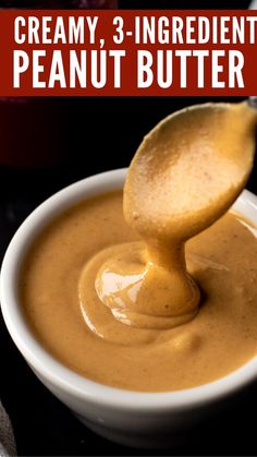 a spoon full of peanut butter in a white bowl with the words creamy 3 ingredient peanut butter