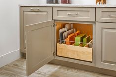 an open cabinet in the middle of a kitchen