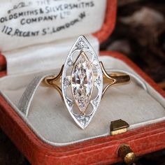 an antique diamond ring sits in its case