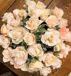 a bouquet of flowers sitting on top of a wooden table