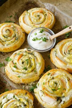 several rolls with cream cheese and herbs on top