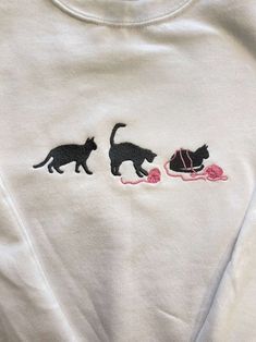 two cats playing with a ball of yarn on a t - shirt that says cat