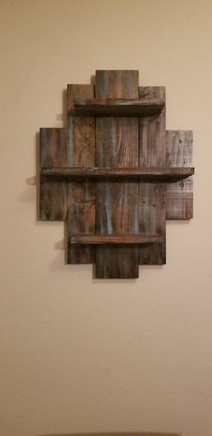 a wooden shelf mounted to the side of a wall