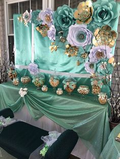 a table topped with lots of different types of flowers on top of a green cloth