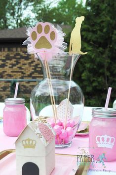 a table with pink and gold decorations on it