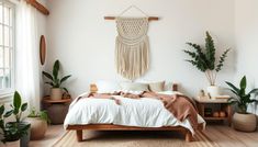 a bedroom with white walls and wooden floors has plants on the wall above the bed