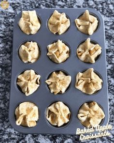 twelve cupcakes in a muffin tin on a granite countertop