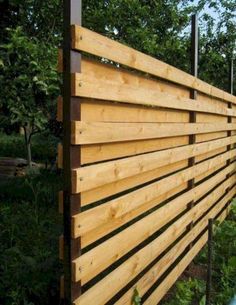 a wooden fence in the middle of a garden