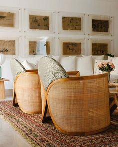 a living room filled with furniture and lots of pillows on top of a rug next to a coffee table