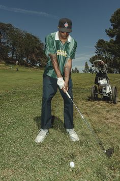 a man is playing golf in the grass with his club and ball on the ground