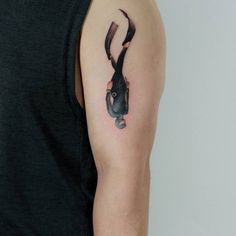 a deer head tattoo on the left upper arm