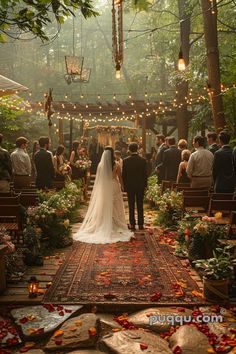 a bride and groom are walking down the aisle at their wedding ceremony in the woods