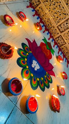 colorful candles are lit on the floor for diwaling