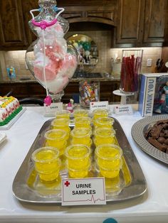 a table topped with lots of cups filled with candy