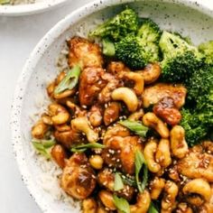 a bowl filled with chicken and broccoli on top of rice next to another bowl