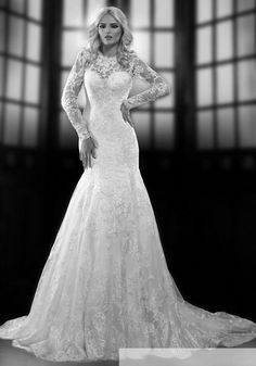 a woman in a wedding dress posing for the camera with her hands on her hips