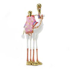 a glass figurine with a camel on it's head and legs, wearing gold shoes