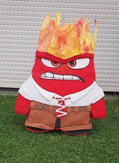 a red and white fireman costume sitting in the grass