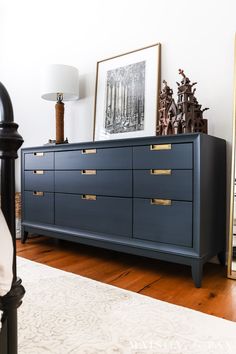 a blue dresser sitting on top of a hard wood floor next to a white rug