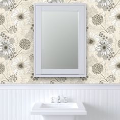 a white sink sitting under a mirror next to a wall mounted faucet in a bathroom