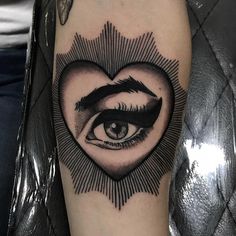 a heart shaped tattoo with an eye inside