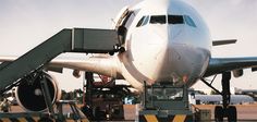 an airplane is parked on the tarmac with it's door open and stairs down