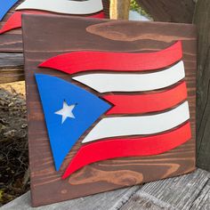 two wooden signs with the american flag painted on them