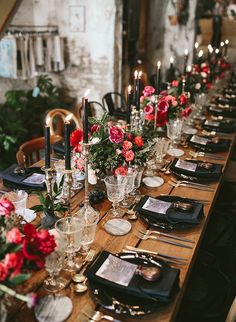 a long table is set with place settings and flowers on it for an elegant dinner