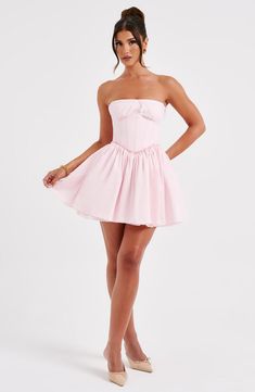 This mini is having a moment! Made in a premium cotton blend fabric, this strapless design features a boned corset to snatch the waist and a super full skirt. The look is complete with delicate lace trims and shirring to the back. 



Colour: Blush.

Premium non-stretch cotton blend fabric.

Fully lined.

Strapless with lace trim.

Gathered, underwired cups.

Boning in corset.

Lace trim detail.

Super full skirt.

Shirred back detail.

Mini length.

Model is an XS and is wearing an XS.

 Size: Corset Dress Short, Short Corset Dress, Homecoming Dresses Corset, 23 Birthday, Corset Dresses, Long Sleeve Homecoming Dresses, Prom Inspo, Hoco Dress, Shirred Dress