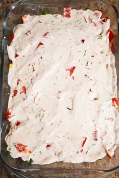 a casserole dish with white sauce and vegetables in it