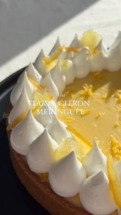 the tart is decorated with lemon and meringue on top, as well as white icing