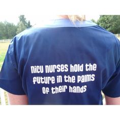 the back of a person wearing a blue shirt with white writing on it that says, ncu nurses hold the future in the palms of their hands