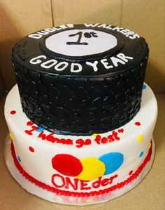 two tiered cake decorated with black, white and red frosting that says good year