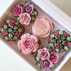 pink and green cupcakes in a white box with flowers on them that say happy birthday