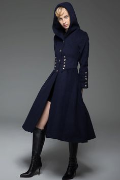 Crafted in warm wool, this navy military style wool long coat is designed to give an up-to-date and modern look with distinctive styling. This is outerwear that will make you stand out in the crowd. Wear this winter staple for perfect off-duty outfitting. The Military Coat features a gorgeous nipped in waist with button details. The hooded coat also has more button details on the cuffs and this detailing gives long hooded coat its military styling. The blue military coat has a fit and flare fit Hooded Pea Coat With Buttons For Workwear, Hooded Pea Coat For Workwear, Fitted Long Pea Coat With Buttons, Hooded Wool Coat With Buttons For Fall, Navy Double-breasted Pea Coat For Winter, Navy Double-breasted Pea Coat With Buttons, Winter Wool Long Coat With Button Cuffs, Military Long Coat With Buttons, Military Style Long Coat With Buttons