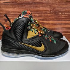 the nike lebrone is decorated with gold and black flowers