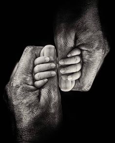 black and white photograph of two hands holding each other