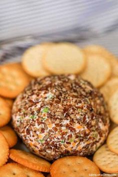 a cheese ball surrounded by crackers on a plate