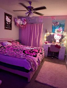 a bedroom decorated in pink and purple with hello kitty decorations on the walls, bedding, dressers, and ceiling fan