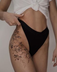 a woman's stomach with flowers on it and the bottom part of her panties