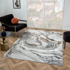 a modern living room with marbled rugs and black chairs