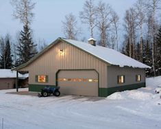 a garage with snow on the ground and trees in the background, along with pictures of it