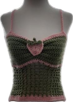 a crocheted tank top on a mannequin's head with a pink bow