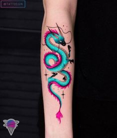 a blue and pink dragon tattoo on the arm