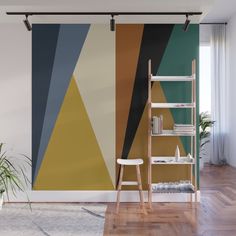 an abstract wall mural in a living room with a ladder and potted plant next to it