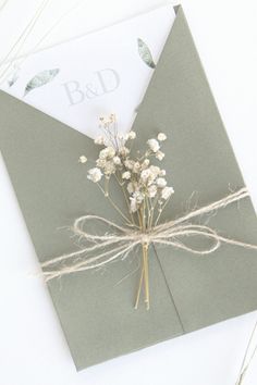 a bouquet of flowers is tied to an envelope