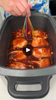 someone is cooking some food in an air fryer with the lid open and colorful wires coming out