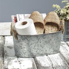 a basket filled with toilet paper on top of a wooden table