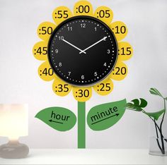 a clock that is on the side of a wall with numbers and flowers in front of it